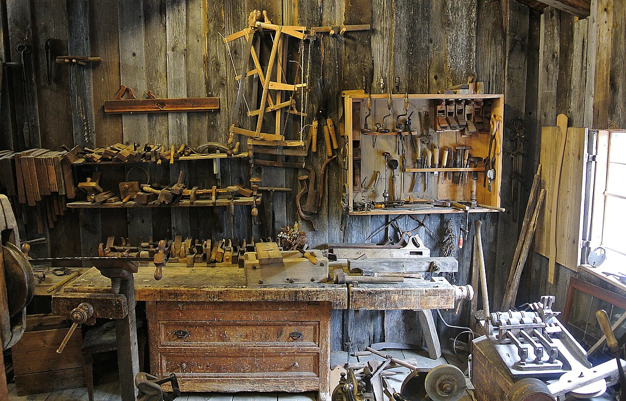 Traditional woodworking tools and a wooden workbench, used as reference craft photography